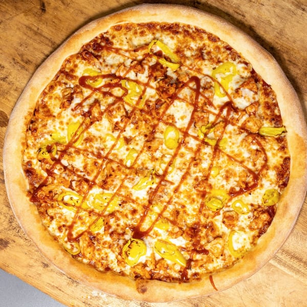 Uncle Vito's Pizzeria's BBQ chicken pizza, topped with melted cheese, banana peppers, and BBQ sauce.